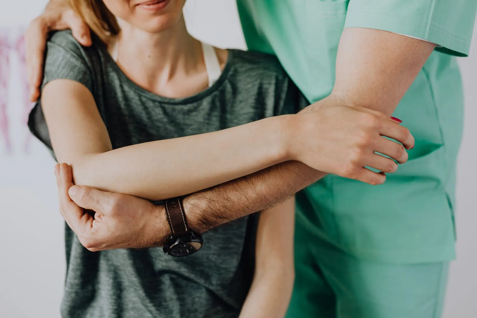 Hands-on physiotherapy treatment of a patient's arm and elbow