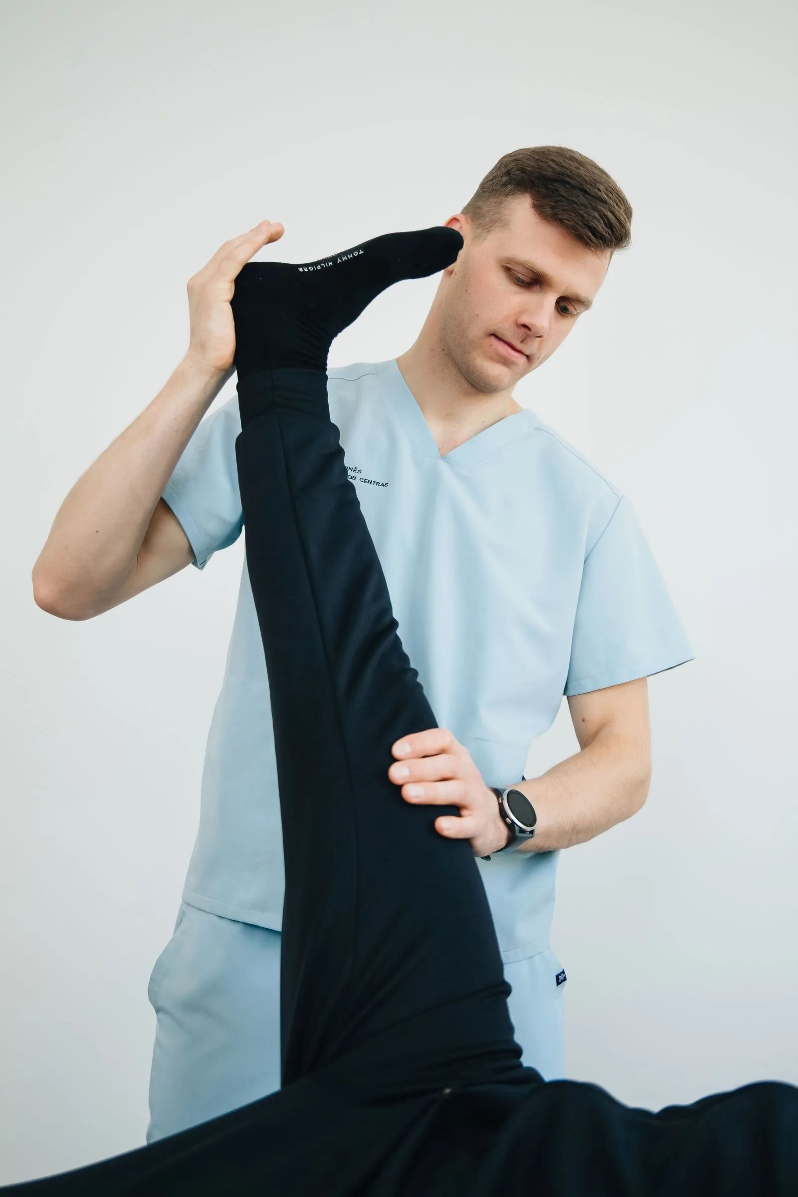A physiotherapist assessing a patient's shoulder movement
